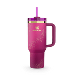 Pink Stanley tumbler with gold stars and a purple straw, featuring the Barbie logo.