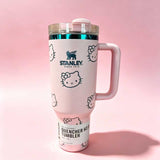 Stanley 40oz insulated tumbler with Hello Kitty full-face pattern on pink background, light pink handle