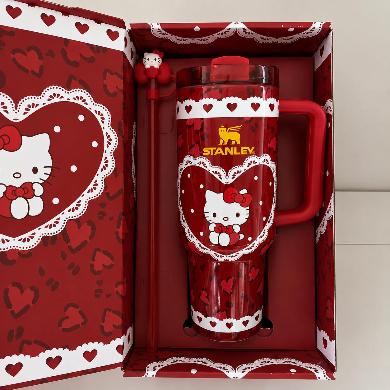 Stanley 40oz insulated tumbler with Hello Kitty heart design, pink background, matching gift box, pink handle