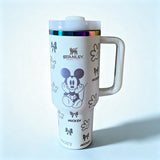 Stanley 40oz insulated tumbler featuring Mickey Mouse illustrations, bows and glove icons, white handle