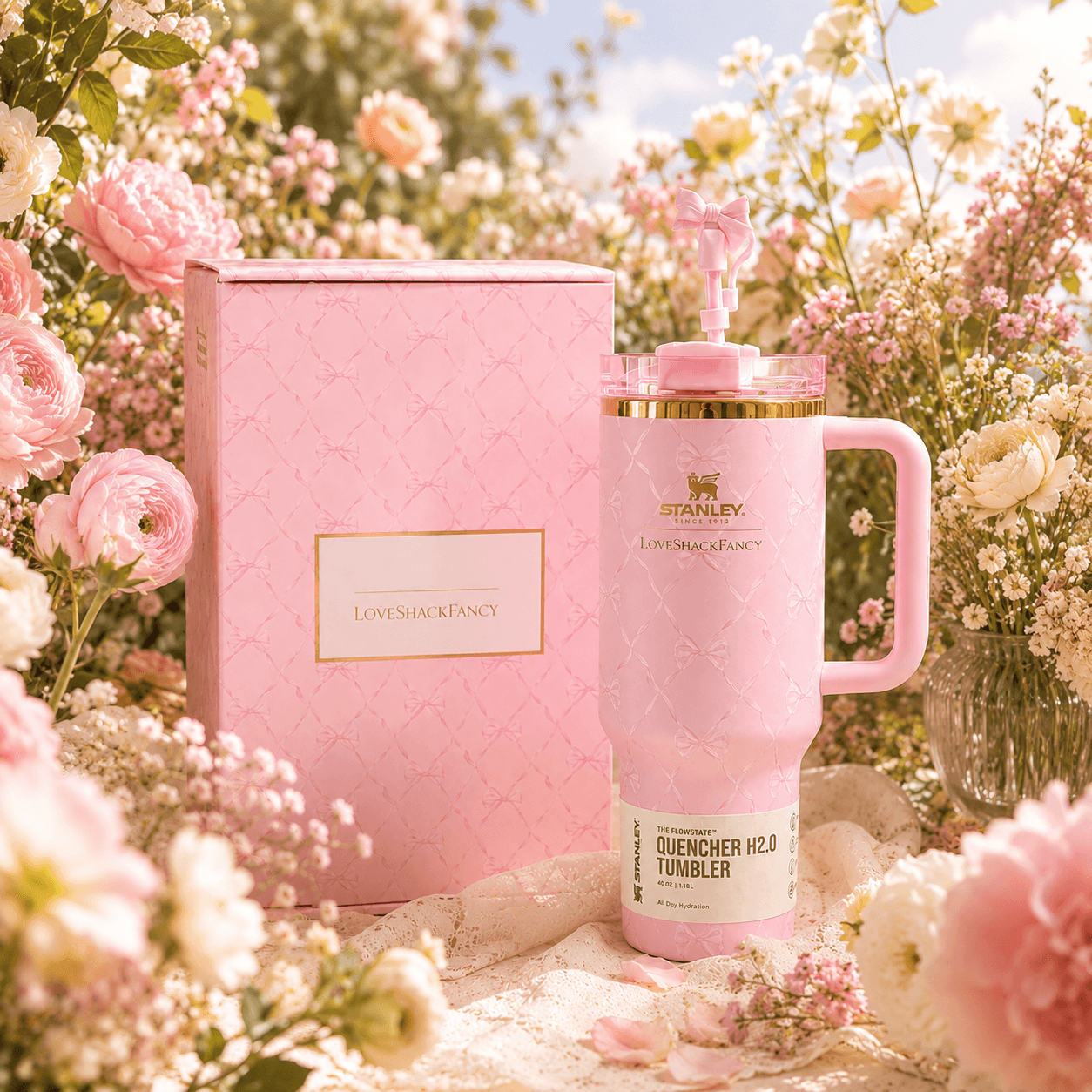 Pink tumbler with handle and matching box on a floral background