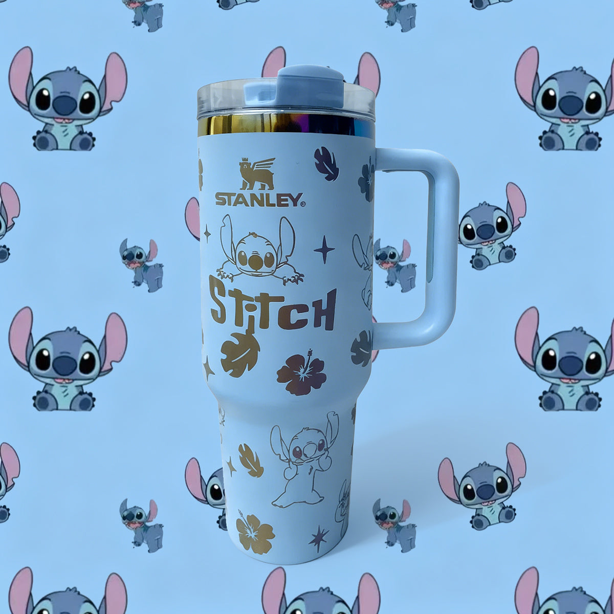 Stanley 40oz insulated tumbler featuring Stitch character illustrations, tropical leaves, and hibiscus flowers, white handle