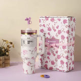 White and pink floral Stanley 40oz insulated tumbler with straw and matching gift box, pink ribbon design