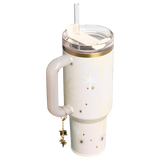White tumbler with gold accents and star designs on a white background