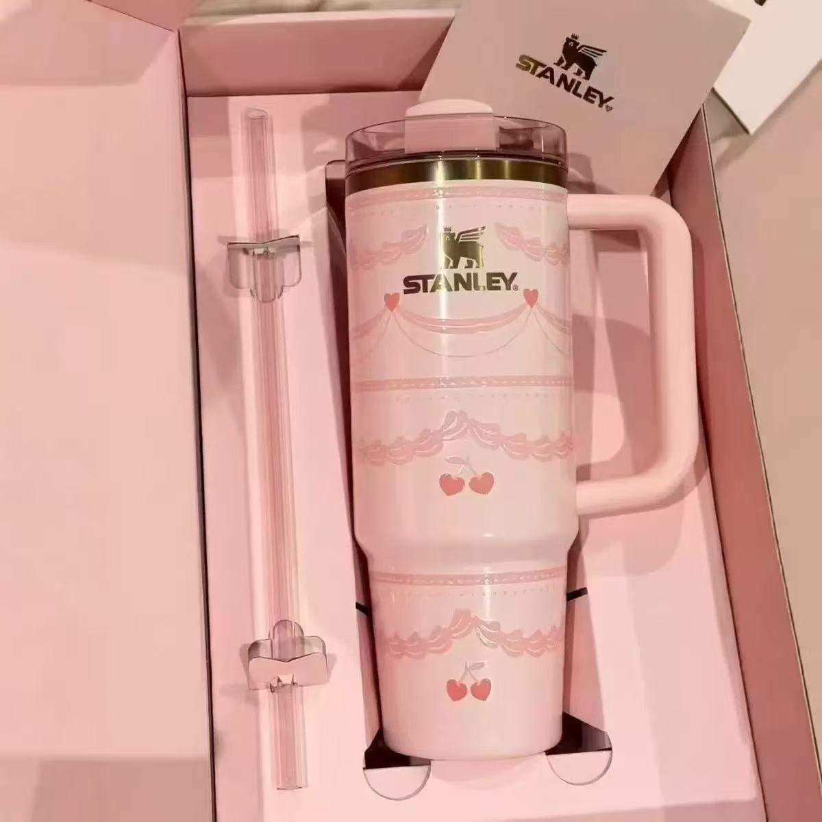 Stanley 40oz insulated tumbler with pink cherry blossom design, pastel background, includes matching straw and gift box, light pink handle