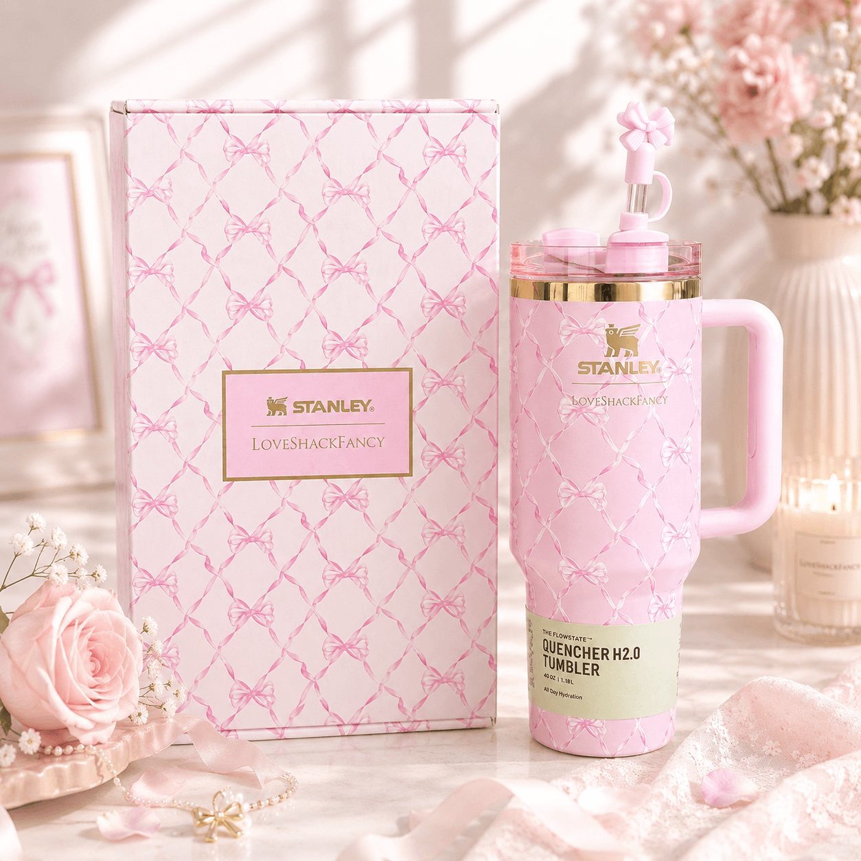 Pink Stanley tumbler with matching box on a decorative surface