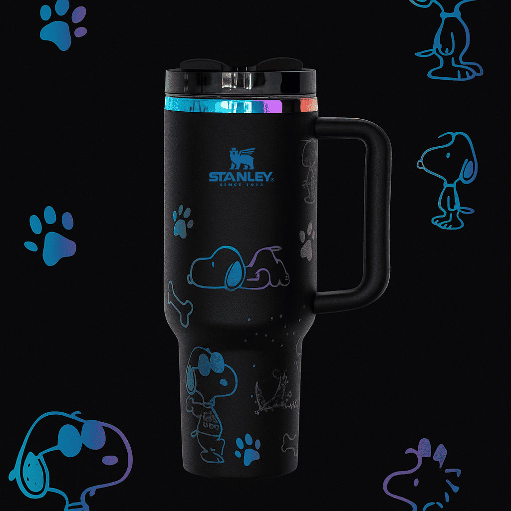 Stanley 40oz insulated tumbler featuring Snoopy illustrations, blue paw prints and bone icons, white body with white ergonomic handle