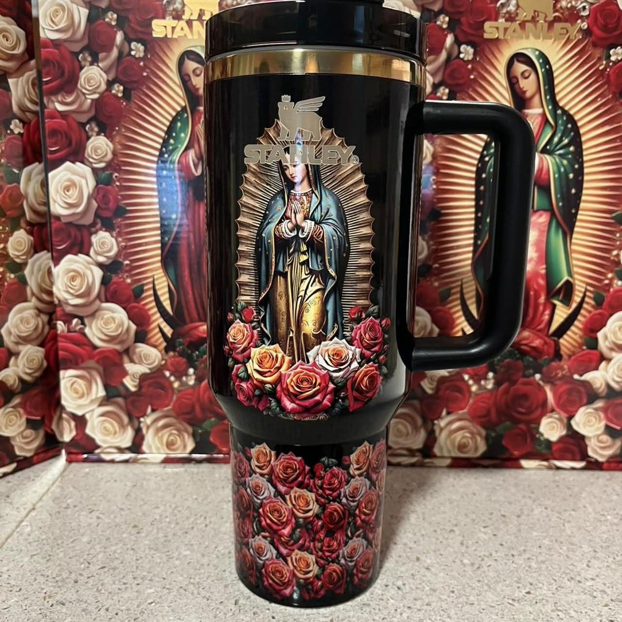 Stanley 40oz insulated tumbler featuring Virgin Mary artwork with rose floral design, black body with gold accents and black handle
