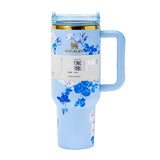 Close-up of the light blue Stanley Quencher H2.0 Tumbler featuring a blue and pink floral print and a gold rim.