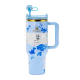 Stanley Quencher H2.0 Tumbler in a blue floral pattern with a straw lid and handle, presented against a white background.